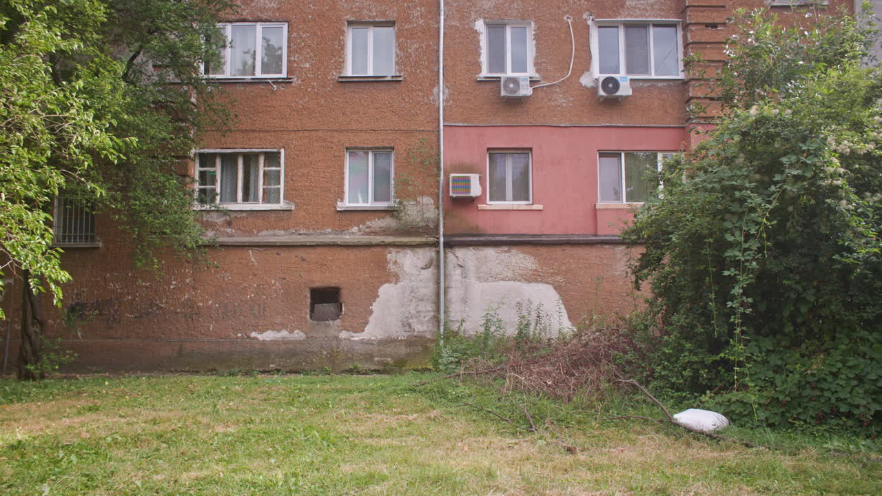 A neighborhood with communist architecture apartment buildings and the surrounding neighborhood environment, garden and trees from the communist era on the Balkans in Sofia, Bulgaria, Eastern Europe
