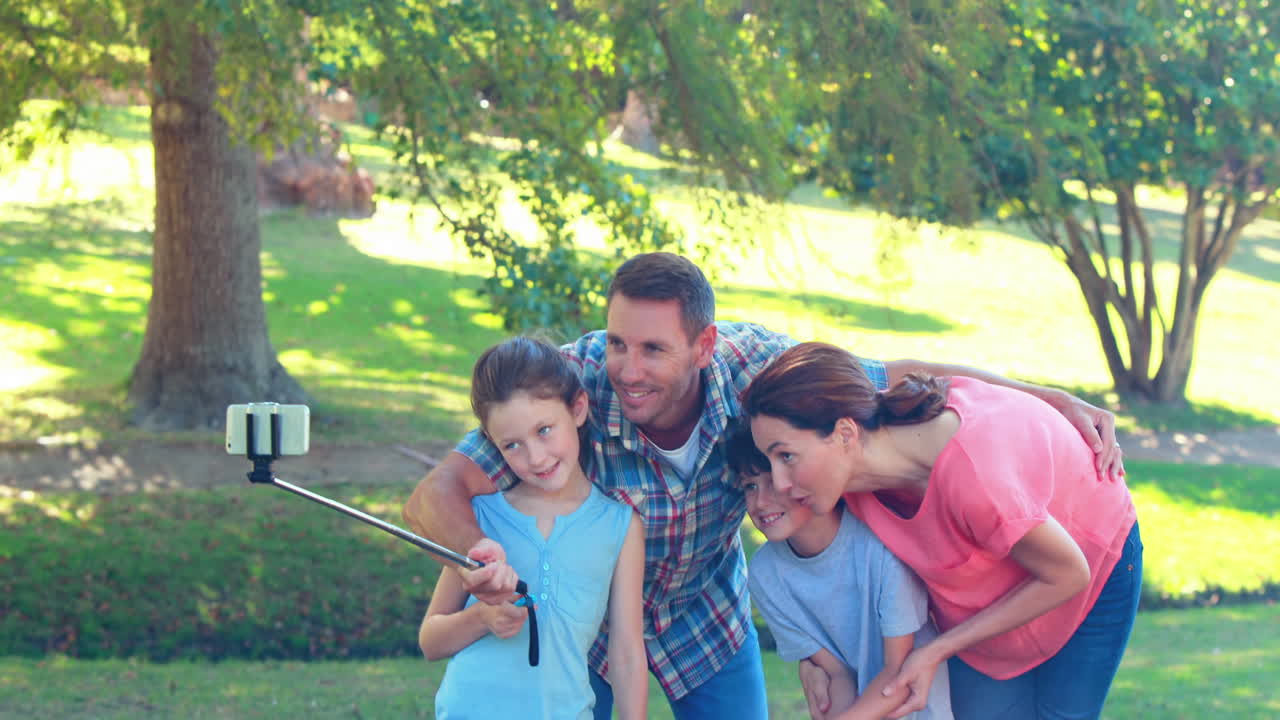 familia feliz tomando una selfie con un palo de selfie