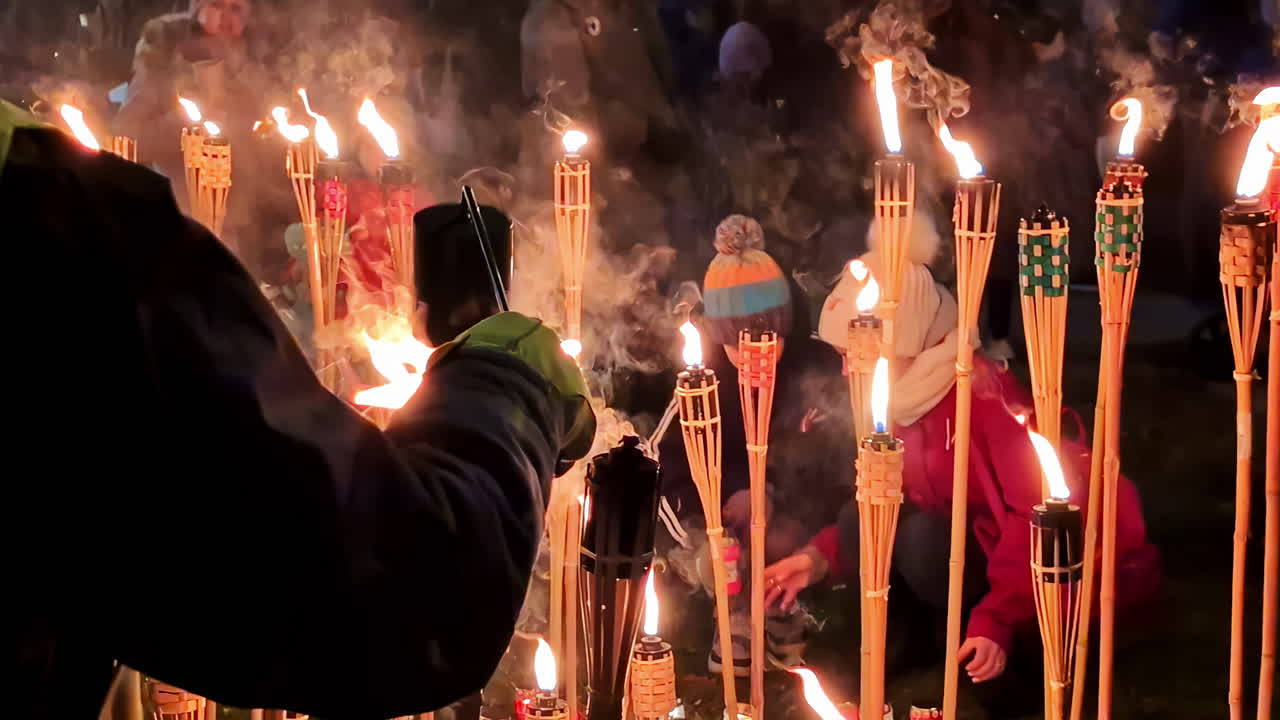People lighting torches at night festival