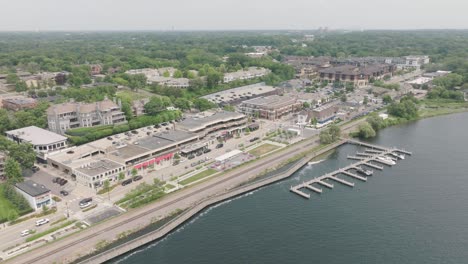 aerial pan shot of downtown wayzata near lake minnetonka with boats docked in usa