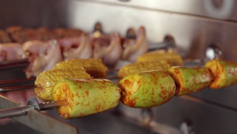 vegetables and meat on a grill in a restaurant.