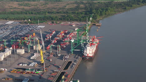 aerial view of cargo ship moored at terminal zárate port full of containers, argentina