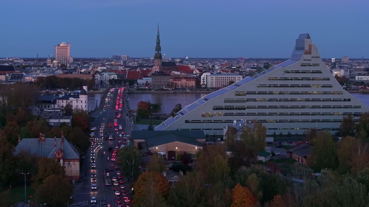 Leftward drone past Riga’s iconic skyline as evening shadows deepen in autumn