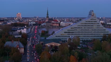 leftward drone past riga’s iconic skyline as evening shadows deepen in autumn