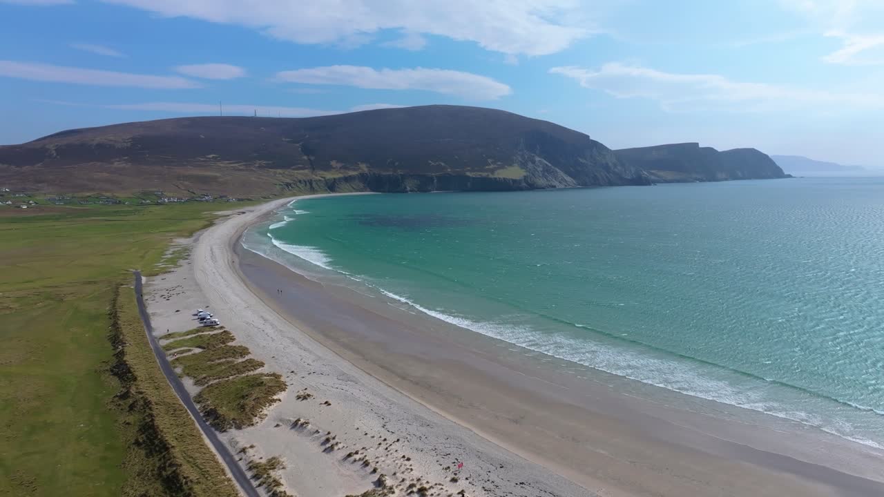 4K cinematic drone footage of Keel Beach on Achill Island, County Mayo, showcasing a long sandy shoreline, rolling waves, and dramatic cliffs along the Wild Atlantic Coast. Ireland_04