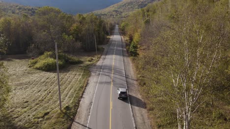 car drive on grafton notch state park valley road during fall golden hour