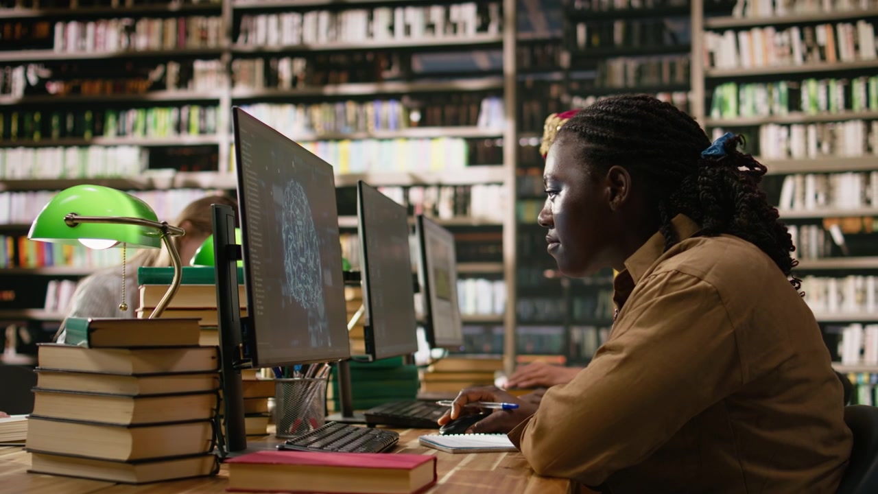 AI brain display filling desktop monitor in library study workspace