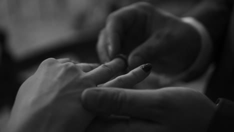 Putting-on-a-wedding-ring-in-slow-motion-black-and-white