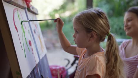 mother and daughters painting together