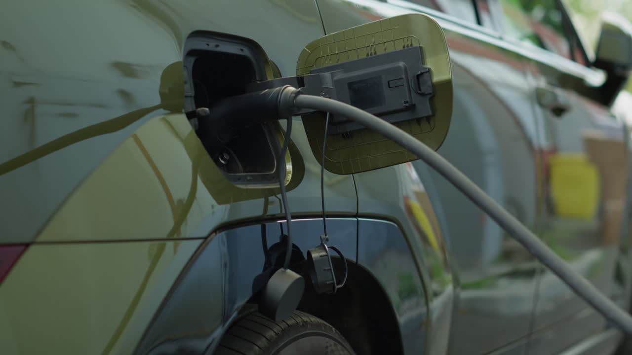 Close Up Of Electric Cable Attached To Ev Car Charging Port To Recharge Battery