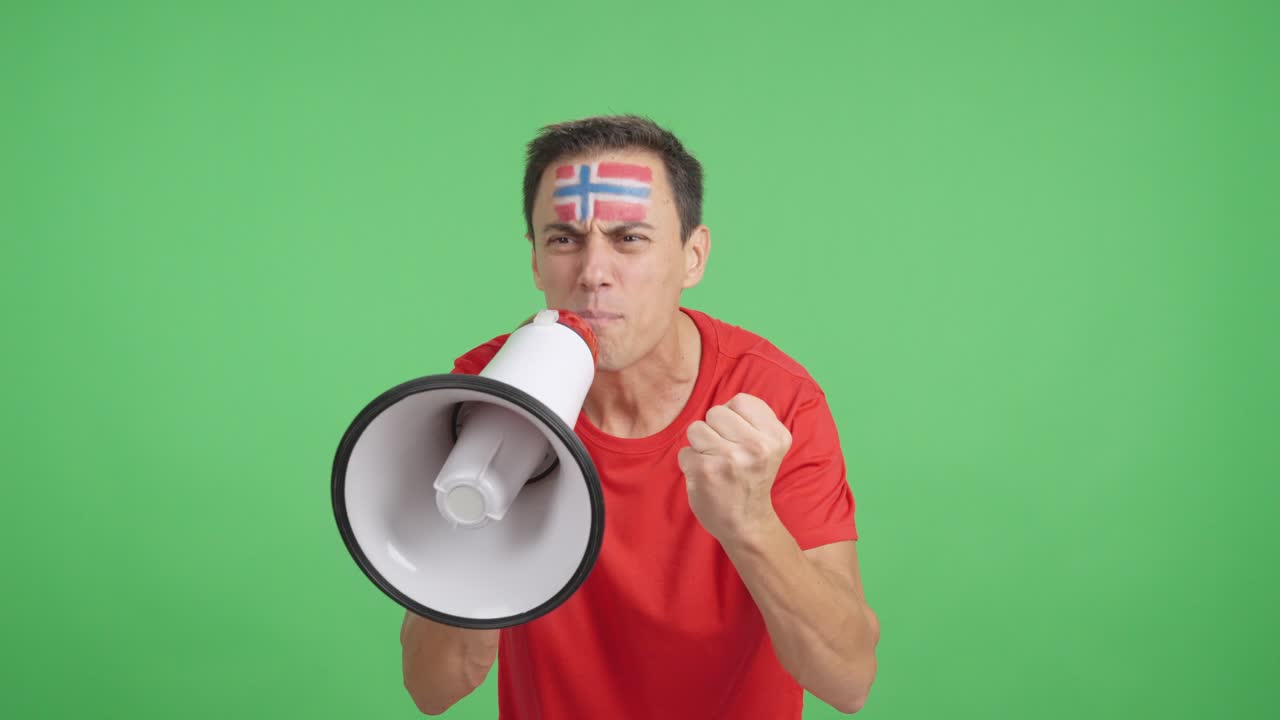 Excited man with norwegian flag on face using a megaphone