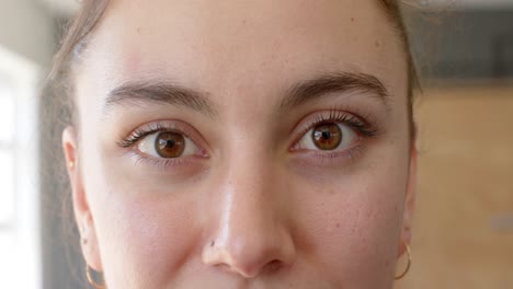 portrait close up of happy unaltered caucasian woman smiling at gym, slow motion