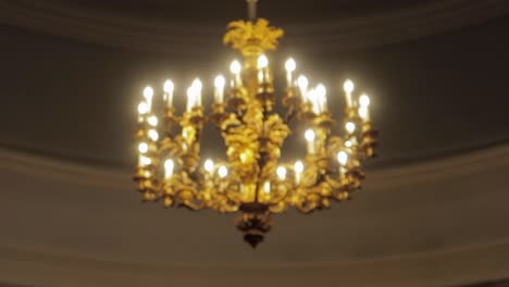 pulling focus on a golden chandelier in a white dome