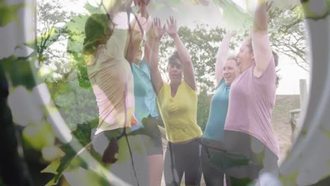 animation of leaves over happy diverse sports women teaming up