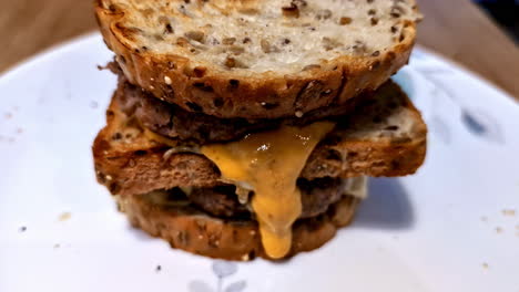 double cheeseburger with melted cheese on toasted bread