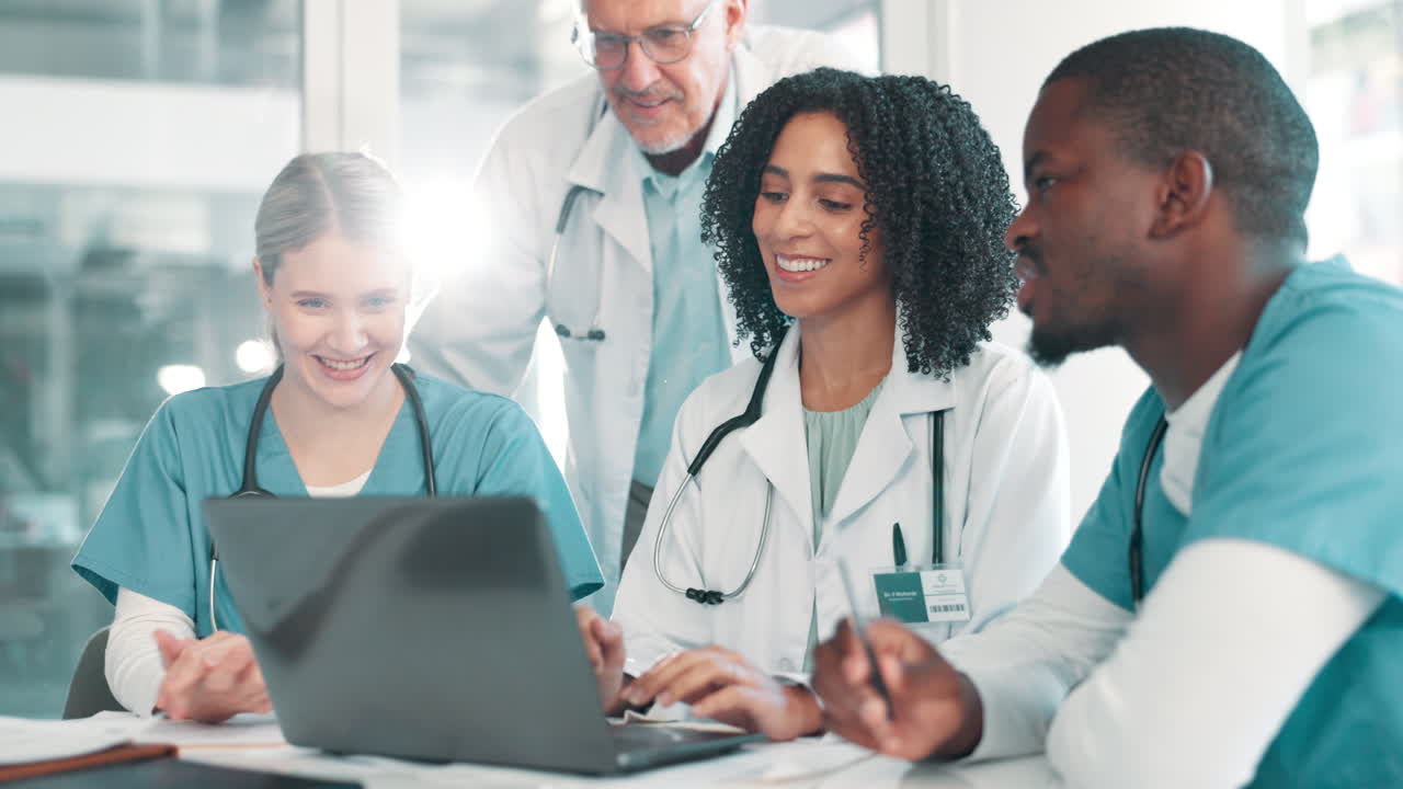 Medical team collaborating on patient care using a laptop