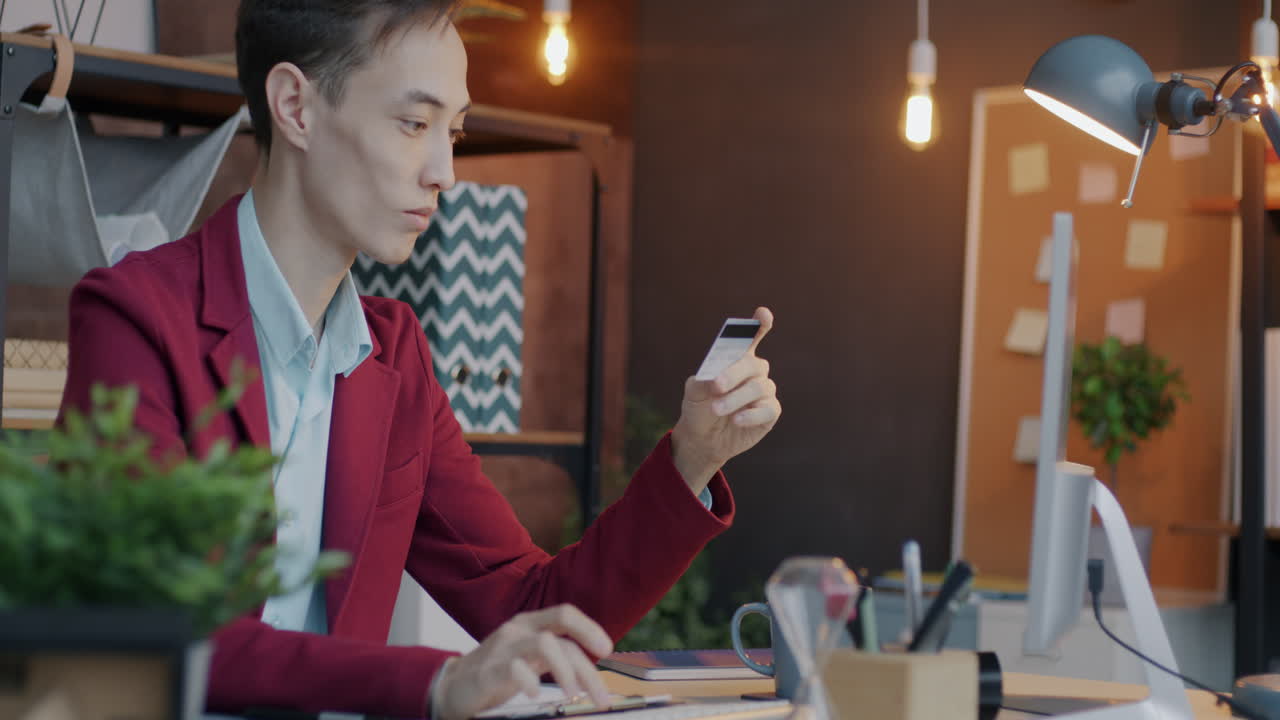 Person Working on a Desk with a Credit Card