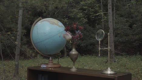 globe and antique stuff on table in the garden