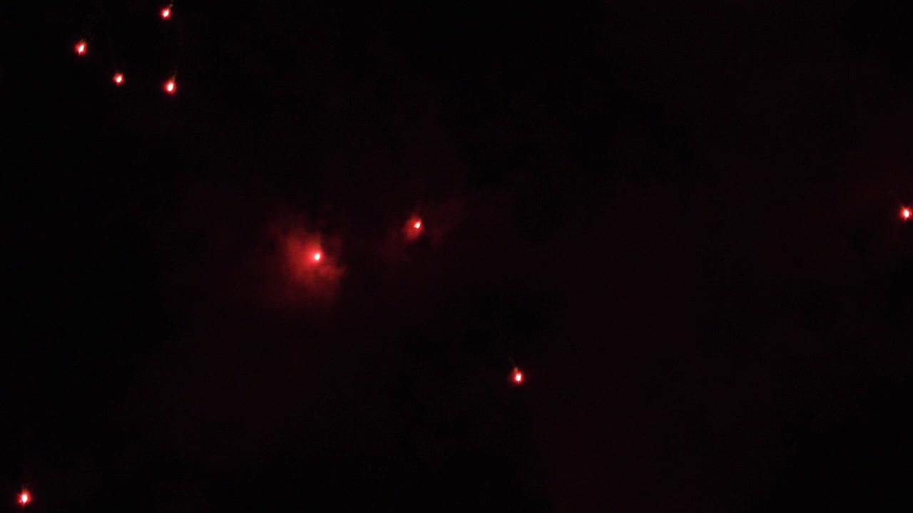Red firework sparks falling in smoke from explosion at night minimalistic graphic background design