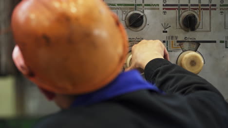 Worker Operating Industrial Machine