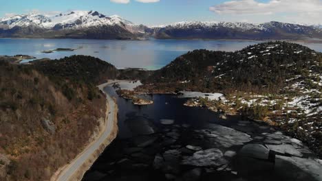 melting ice layer of a lake in the middle of a beautiful valley