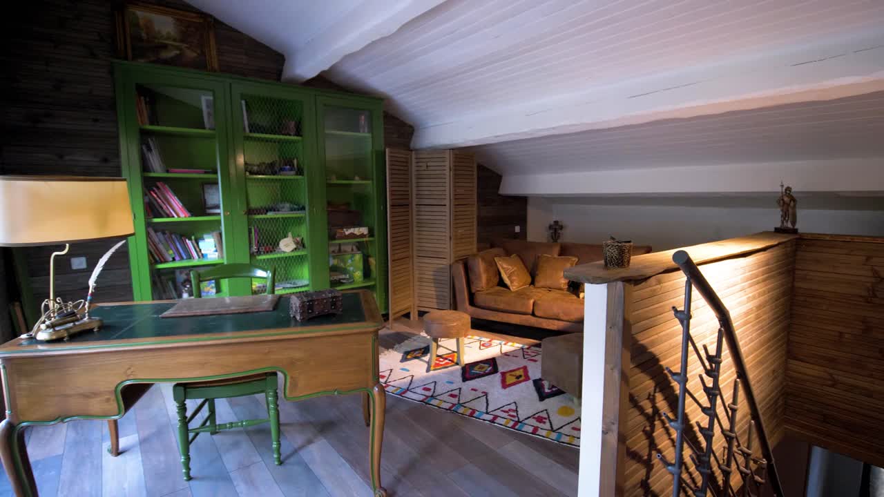 Slow establishing shot of an antique office within an attic in a villa