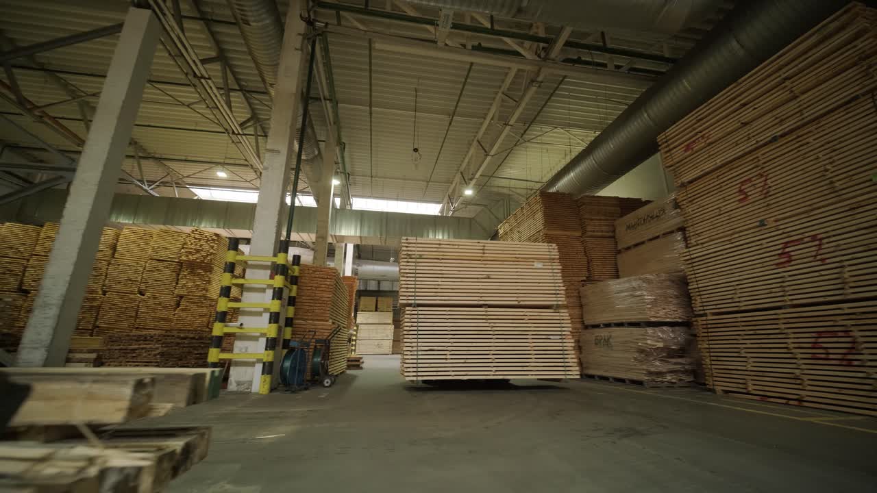 Large Stacks of Lumber Moving in an Industrial Warehouse