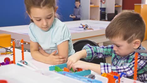 children playing with educational building blocks in a classroom