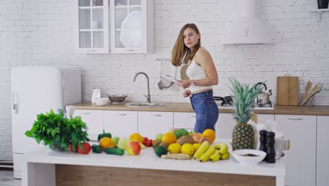 young female with tablet in the kitchen. attractive woman trying to find recipe for diet food in her laptop indoors. healthy diet eating.