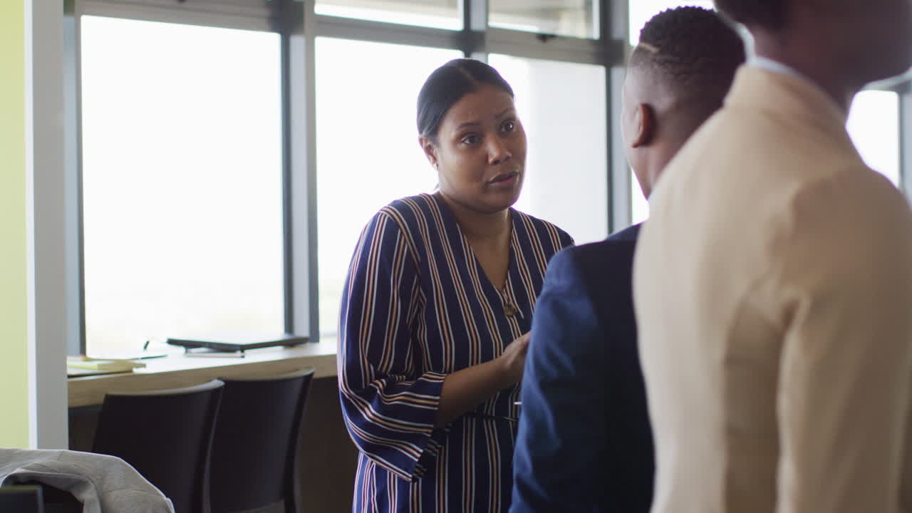 African american business people discussing work at office, slow motion