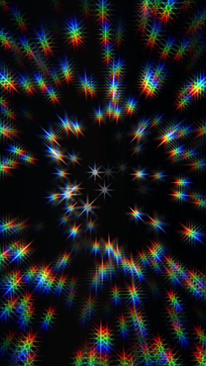 Seamless loop of a spiraling vortex of rainbow-colored starbursts on a black background. Vertical format for parties, music events, VJ loops, or pride celebrations