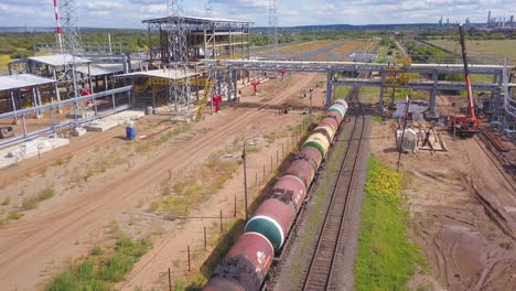 refinería de petróleo con vagones cisterna y construcción