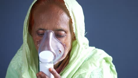 elderly woman receiving nebulizer treatment