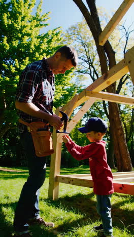 father and son building a wooden structure