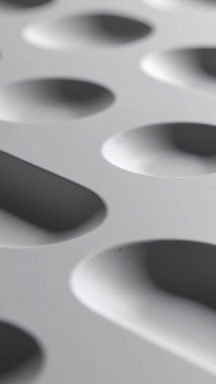 Vertical video: Opening cut starting cam gliding over studio panel revealing pill round recesses