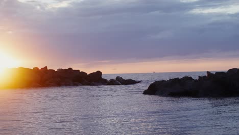 sunrise over the ocean with rocks