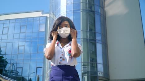 african american girl removes a medical mask. end of quarantine. stop virus