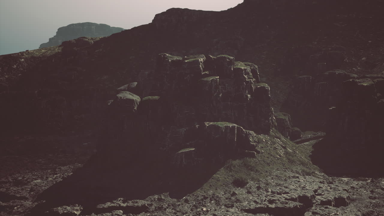 Rugged rock formations under a cloudy sky in a remote landscape