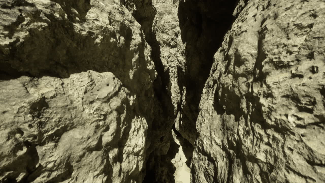 Narrow canyon with rugged rock formations in a desert setting