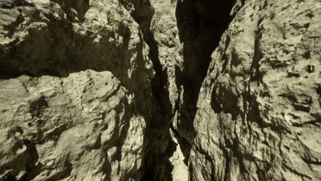 narrow canyon with rugged rock formations in a desert setting