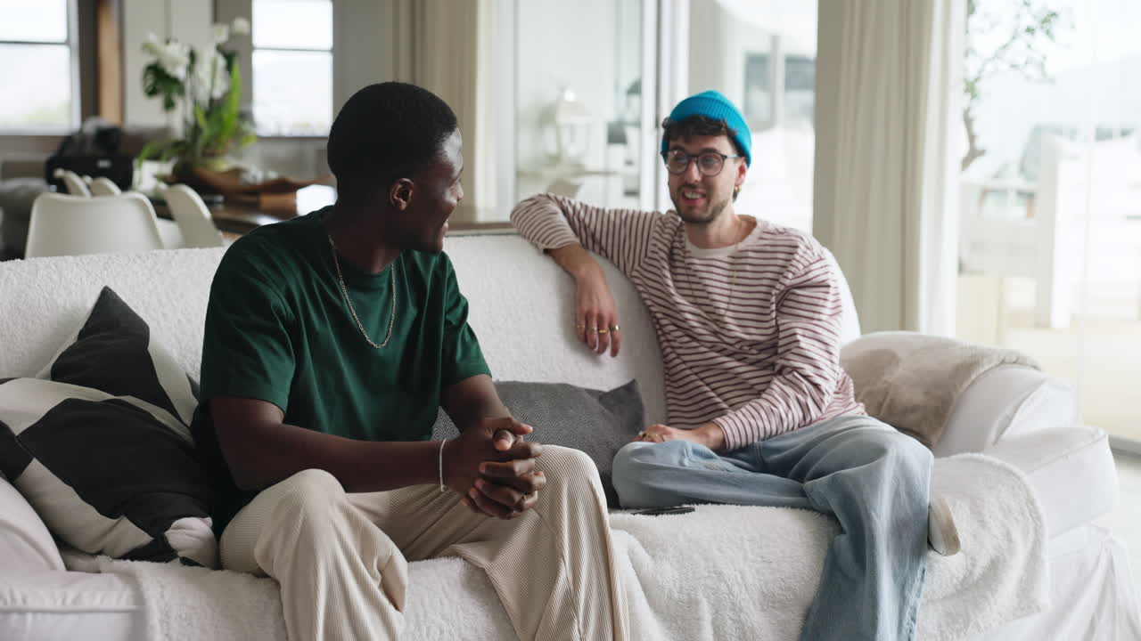 Two Young Men Relaxing and Chatting on a Couch