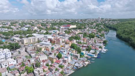 vista aérea de la ciudad de la romana con casas coloridas en la orilla del río durante un día nublado, república dominicana