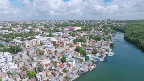 aerial view of la romana city with colorful houses at river shore during cloudy day, dominican republic