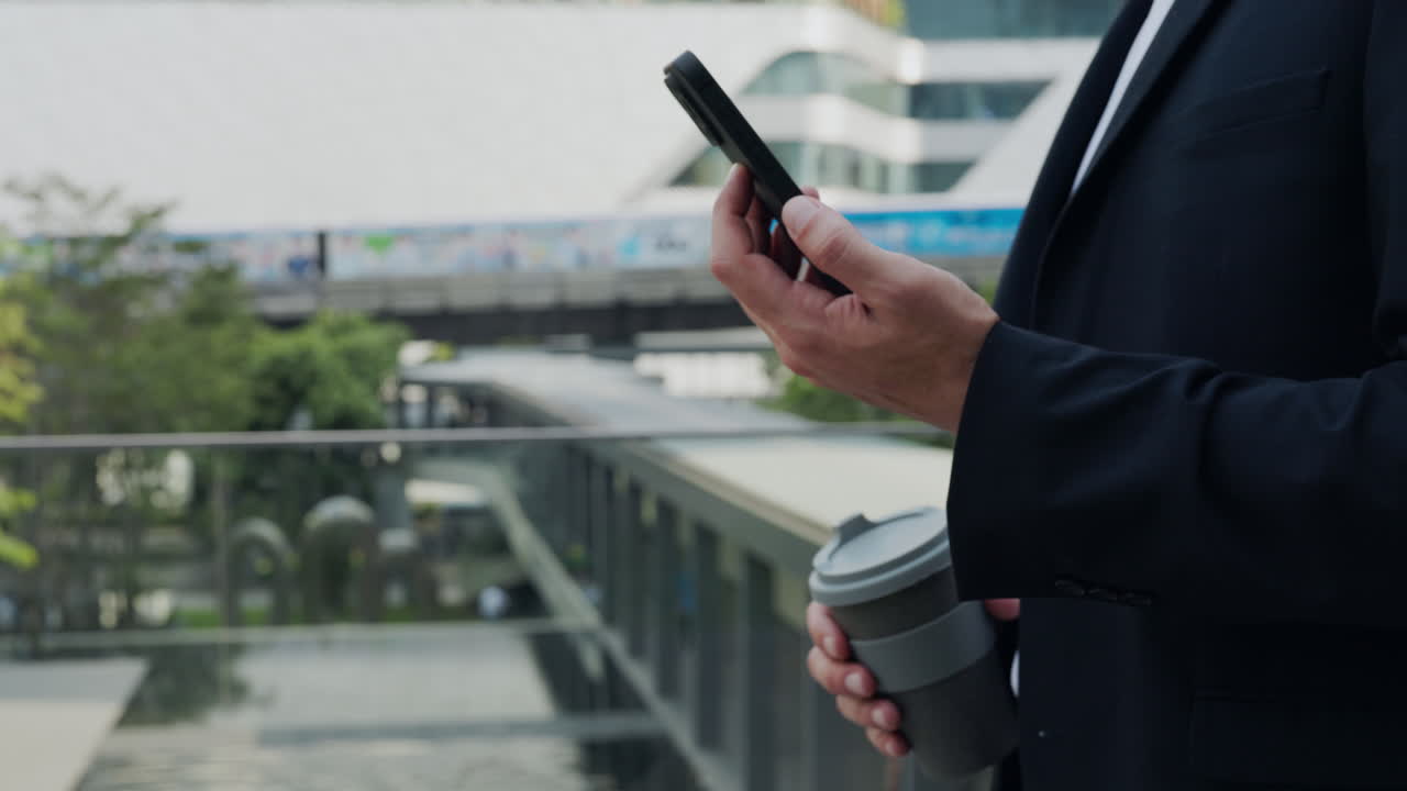 Businessman Using Phone in City
