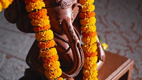 ganesh statue with marigold garland