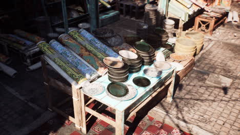 traditional middle eastern market with plates and rugs for sale