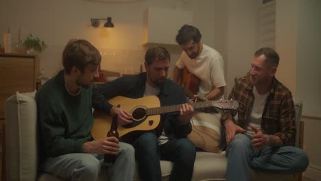 friends playing guitar at home