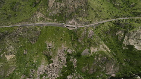 Traveling-Across-Mountain-Pass-Above-Flowing-Stream-Of-Kura-River-Near-Tmogvi-Fortress,-Georgia