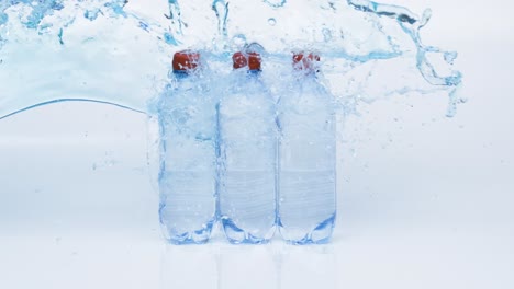 fresh drinking water bottles in splash blue water. shot on super slow motion camera 1000 fps.