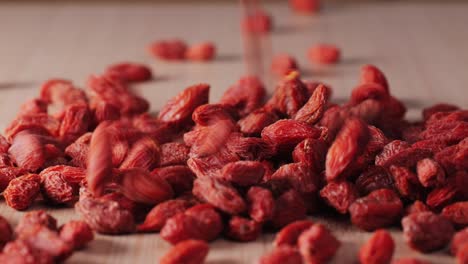 dried goji berries on wooden surface